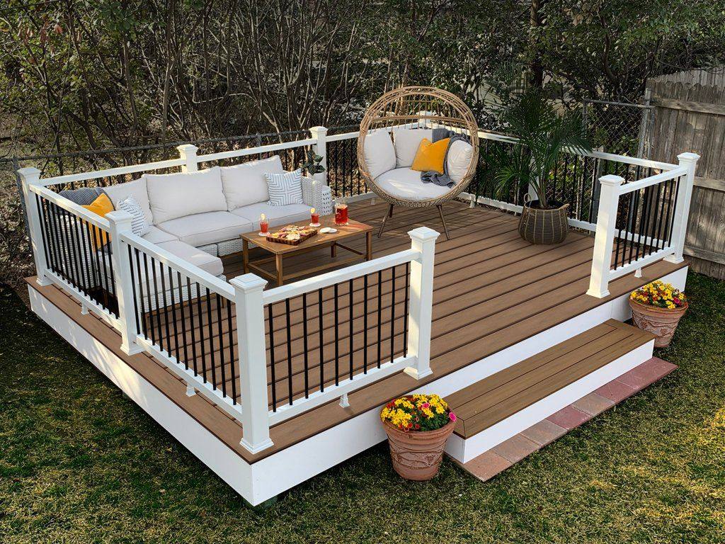 Clean garden decking with white railings and seating